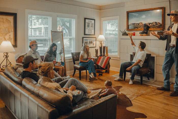 Guests on leather sofas listen to a speaker during a group boot fitting at Chisos HQ
