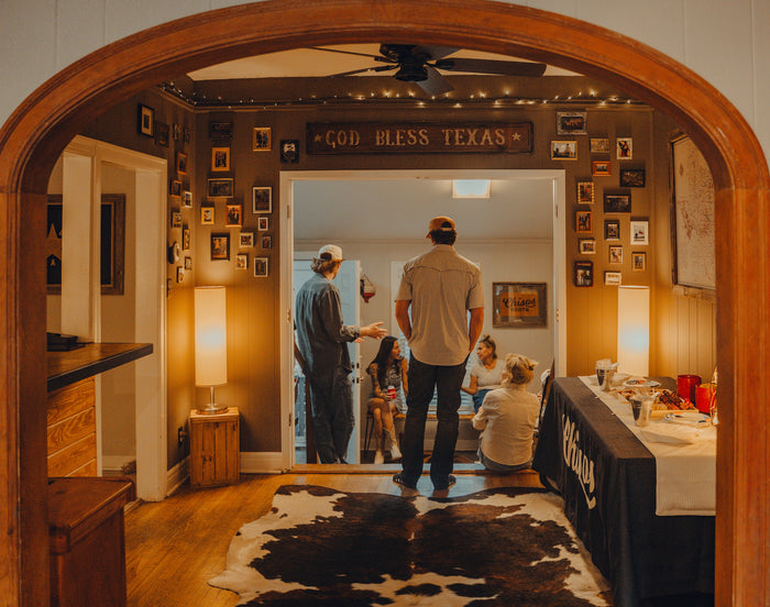 Guests seen through an arched doorway during a private event at Chisos HQ