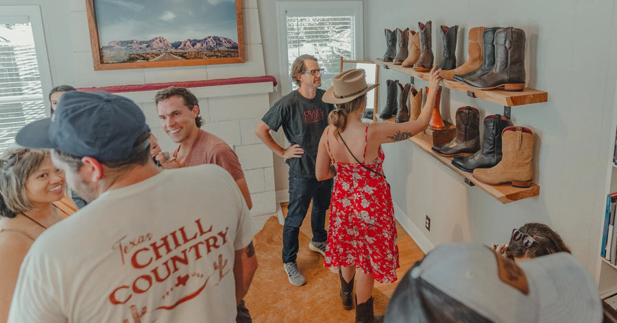 Guests talk near the boot wall during a group event at Chisos HQ