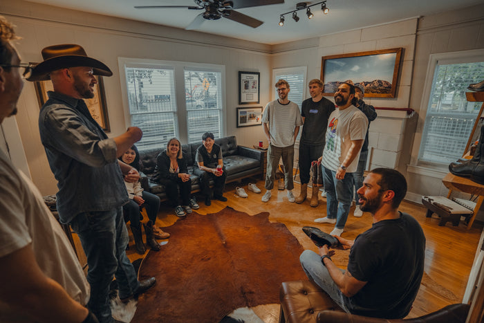 A group gathers in the main room at Chisos HQ during a private boot fitting