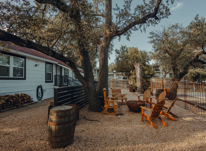 Chairs gathered in the shaded backyard at Chisos HQ